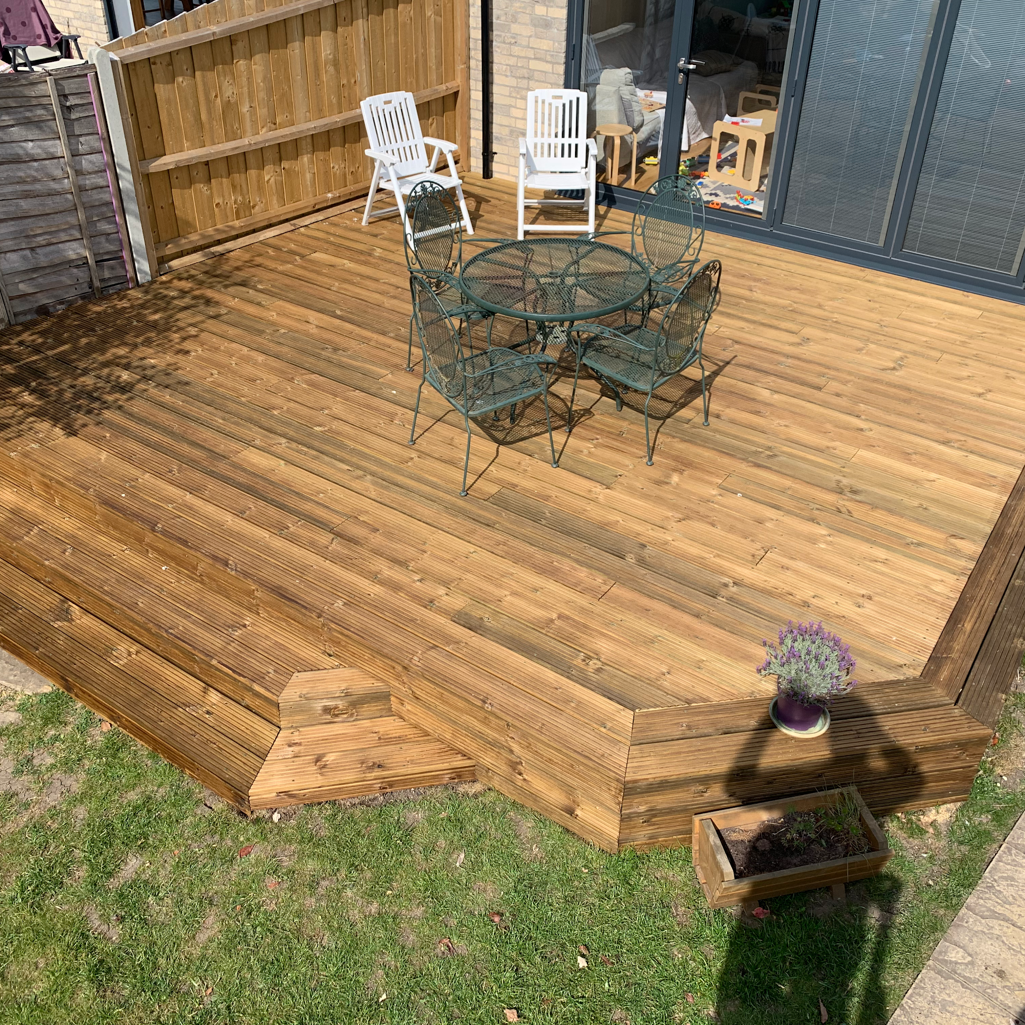 A new timber deck with a step, finished and ready for the garden furniture