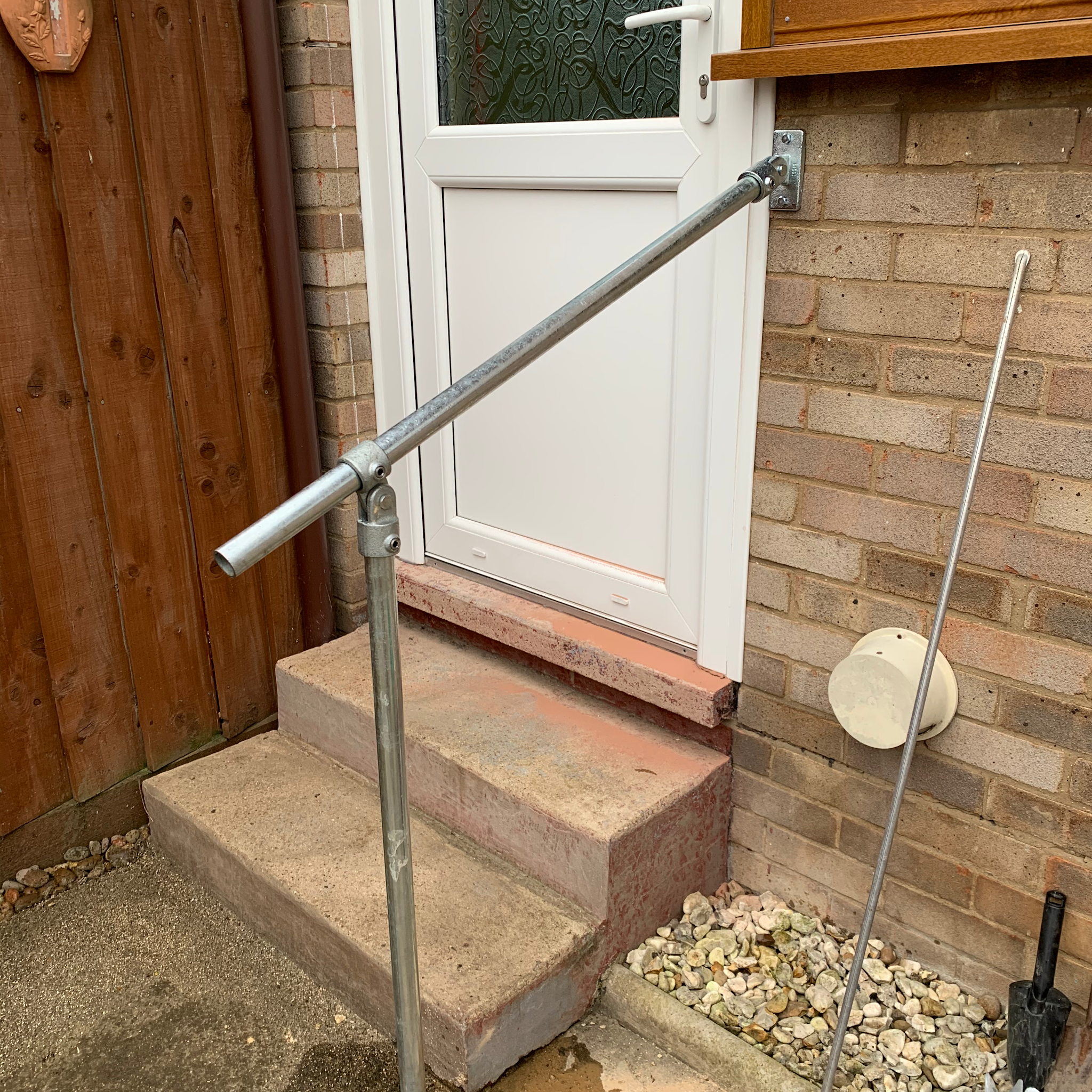 Galvanised handrail fitted beside back door steps